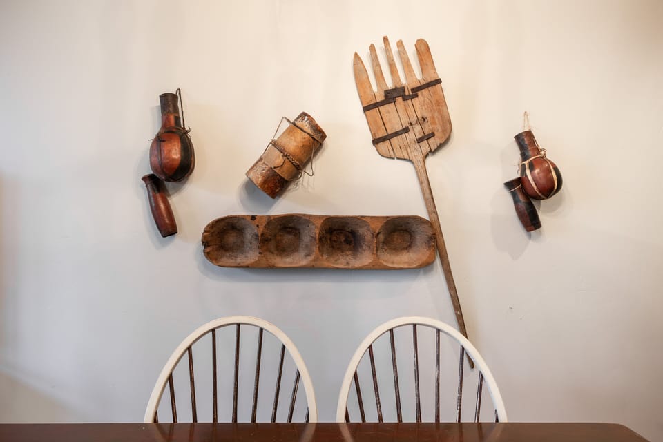 - Rustic wall décor adds authentic lodge character  
- Unique vintage tools displayed for mountain charm  
- Warm dining area accent with artistic farmhouse feel