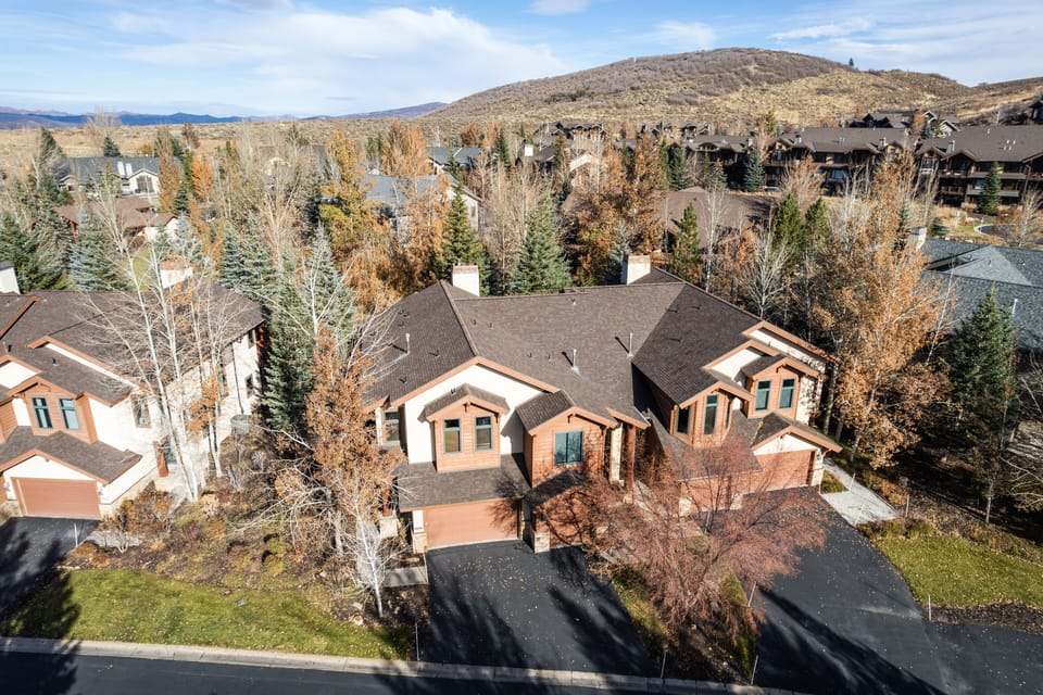 - Aerial view shows townhouse retreat nestled among tall trees  
- Beautiful design combining rustic style with modern comfort  
- Scenic neighborhood perfect for family or group getaways