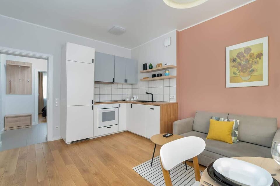 Another view of the dining area, featuring a small sofa and decorative accents.

