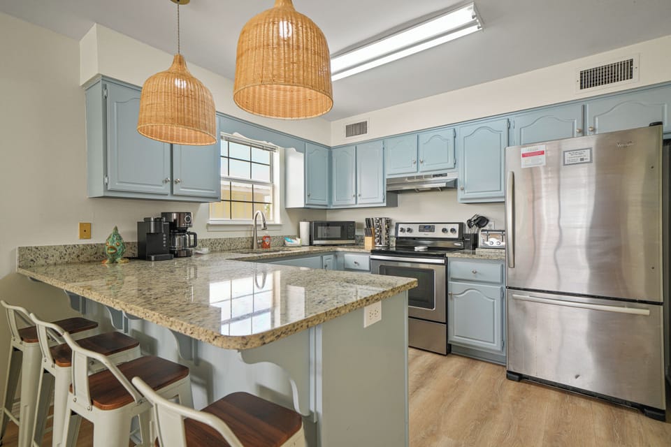 Bright kitchen with a large island, bar seating, and modern appliances—ideal for casual meals, coffee, or gathering with the group.
