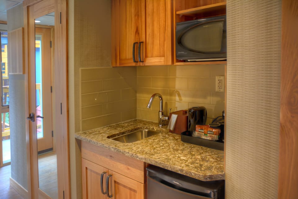 The small kitchenette features a mini-fridge, microwave, and a sink for your convenience.