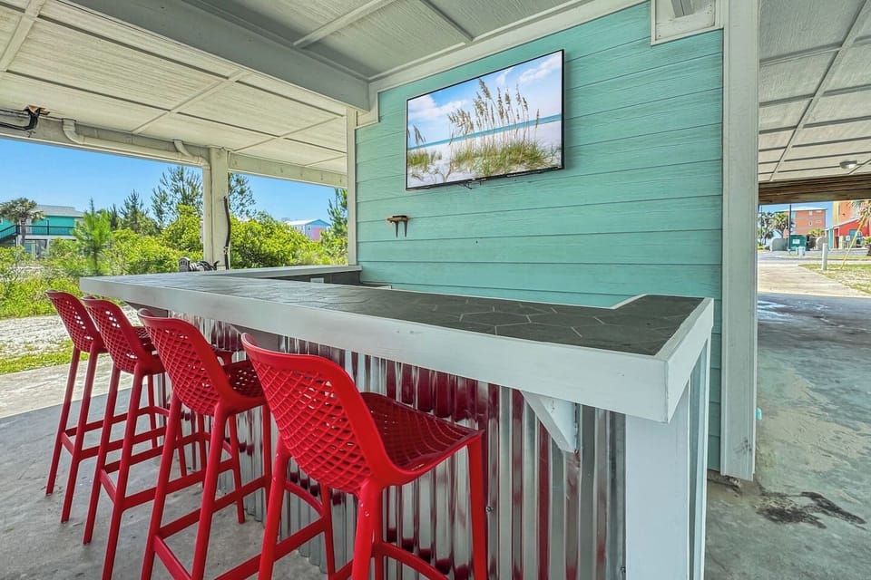 Kick back at your outdoor bar! Complete with bar stools, mounted smart Roku TV, and cool coastal vibes. 
*This is a duplex and the outdoor space is shared with guests in the unit next door