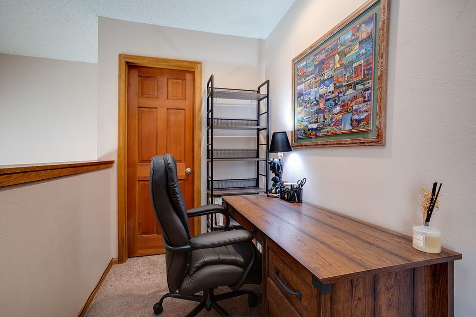 Your private office space awaits with a spacious wooden desk and ergonomic chair, perfect for productive work sessions during your stay.