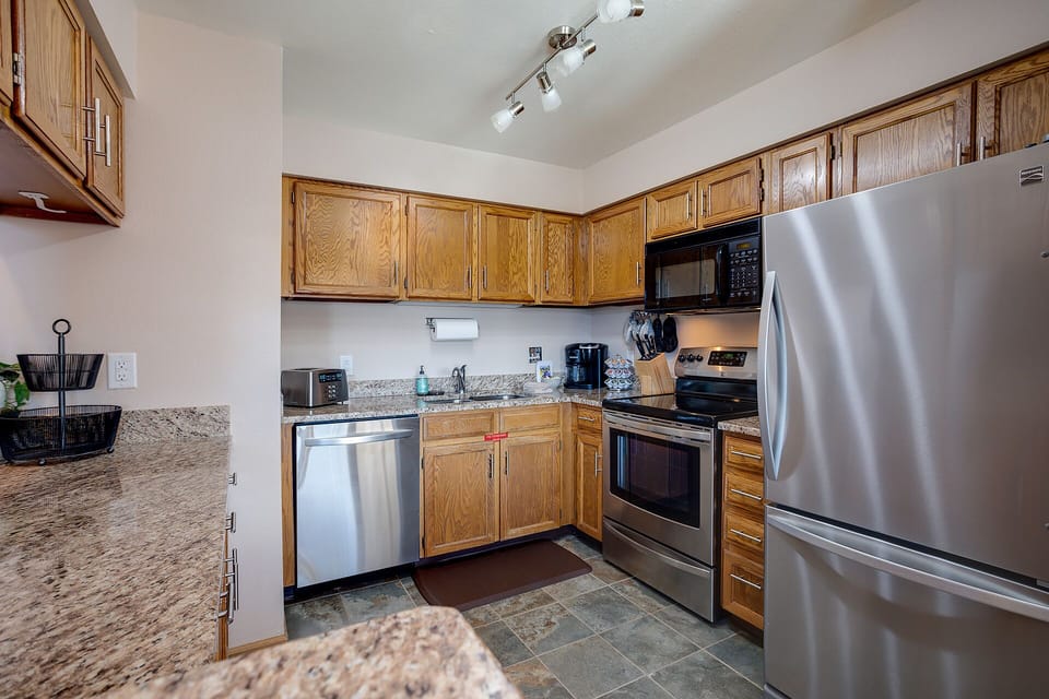 Your fully-equipped kitchen features granite countertops, stainless steel appliances, and plenty of storage for preparing memorable meals during your stay.