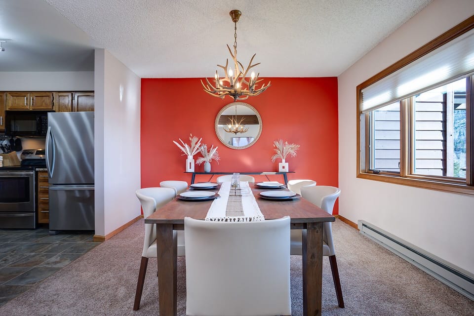 Gather around your elegant dining table for memorable meals, where rustic charm meets modern style under a stunning chandelier.