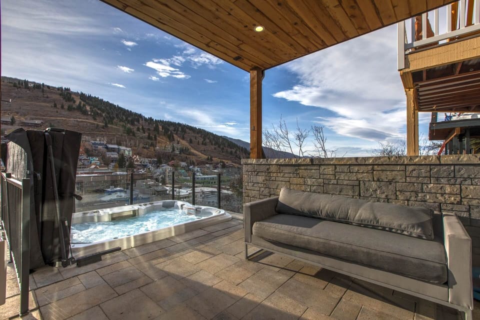 Unwind in your private hot tub while soaking in stunning mountain and valley views from your covered balcony—a perfect retreat after a day exploring.
