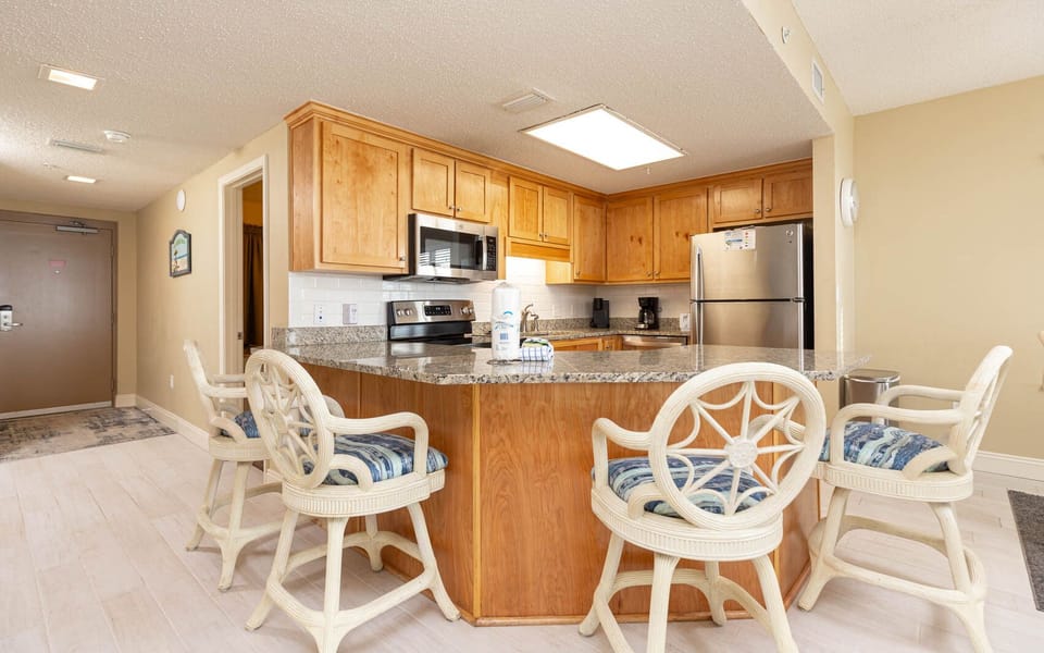 Gather around the stylish bar seating as you enjoy meals prepared in the well-designed kitchen with granite countertops