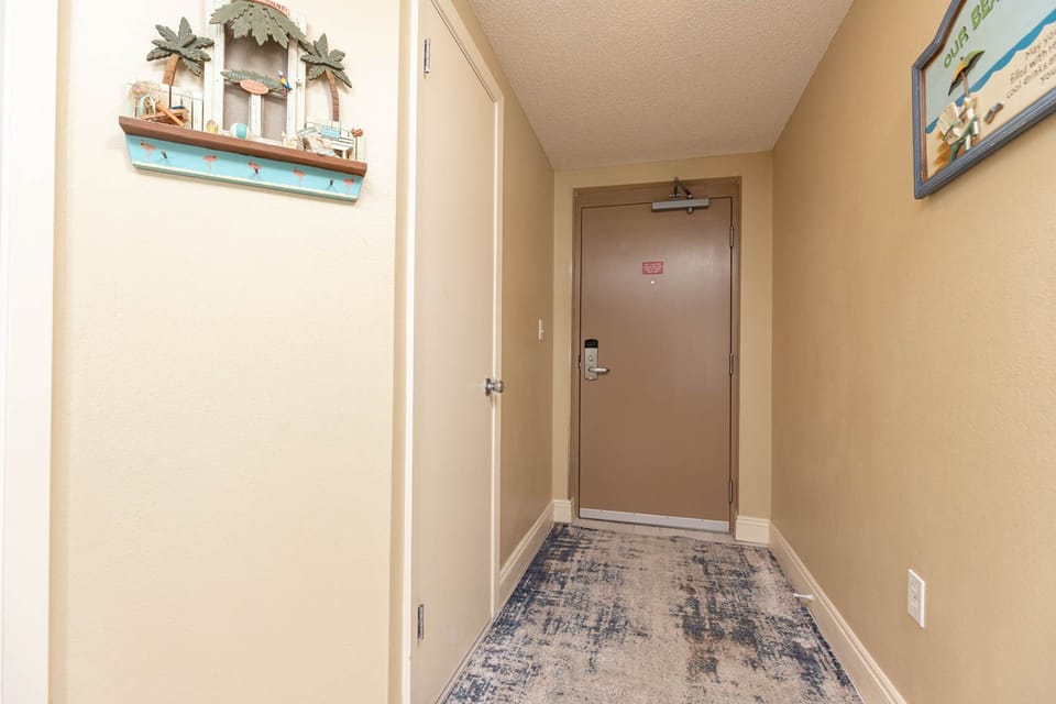 Step into a welcoming hallway adorned with charming decor and a cozy rug, setting the tone for your beach stay