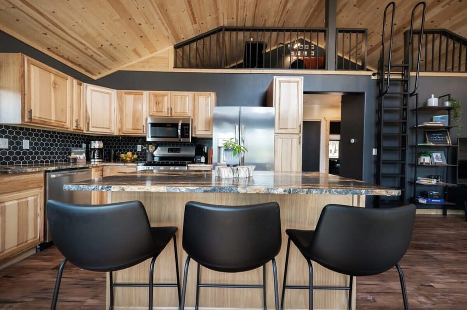 Skip to content Start your search Location Anywhere Check in / Check out Any week Guests Add guests Switch to hosting    1 Soaking Tub, Sauna, Forest + Mountain Views  Share  Save       Show all photos Entire cabin in Florissant, Colorado 4 guests2 bedrooms2 beds2 baths Guest favorite One of the most loved homes on Airbnb, according to guests Rated 4.97 out of 5 stars. 4.97 30 reviews 30 Reviews  Host profile picture Hosted by Jacquie Superhost9 years hosting Dedicated workspace A common area with wifi that’s well-suited for working. Self check-in Check yourself in with the keypad. Jacquie is a Superhost Superhosts are experienced, highly rated Hosts. ✷Deck w/Forest + Mountain Views ✷Sauna ✷RV 30/50a plugs ✷Fenced in yard ✷Firepit ✷Grill ✷Corn Hole, outdoor dining, hammocks ✷2 Memory Foam King beds + 2 Bathrooms ✷Vintage Clawfoot Tub ✷Fully stocked kitchen w/waffle & bread maker ✷Smart TVs in LR + BDRM ✷A/C + Heat ✷Electric Fireplace ✷Family: Pack n play, bath, highchair + monitors ✷Business: Desk Loft, keyless entry, WiFi ✷Close to world class fishing @ Elevenmile Canyon, Lake George ✷20 min to Woodland Park, 1hr to CO Springs or Buena Vista  The space Nestled in the mountainous forests of Colorado, this dreamy two-bedroom, two-bath cabin with a steam sauna offers you a secluded retreat amidst nature's grandeur. Surrounded by towering Ponderosa Pines and Aspens, you'll discover your very own haven, where you can unwind and recharge. This home is located in a nationally registered dark sky zone, so it’s perfect for stargazing and photographing the Milky Way.  Situated at just over 9,000 feet above sea level, the cabin offers gorgeous mountain views from the porch and a sense of seclusion that will transport you far from the worries of everyday life.  The luxurious deck provides the perfect space to sip on a glass of wine while watching the sunset over the mountains, enjoy your morning cup of coffee and a good book, grill dinner for the family or even practice your yoga poses.  No need to leave your culinary and entertainment skills behind. The cabin boasts an open living room, fully equipped kitchen, and inviting dining area. The space was designed and outfitted so you can enjoy all the creature comforts of your home, on vacation.   Ultimate Outdoor Oasis: String Lights, Al Fresco Dining, Mountain + Forest Views, Grill, Sauna and Yard Games Escape to your outdoor retreat, where you can immerse yourself in the beauty of nature and stunning mountain vistas. Step onto the expansive deck, accessible through a sliding glass door, and feel a sense of serenity wash over you. The fully fenced backyard and deck offer a safe haven for your pets or little ones to play, ensuring their enjoyment and your peace of mind. To enhance your outdoor adventure, a deck box holds a variety of outdoor games, including ring toss and more.  Relish in the company of loved ones while savoring the flavors of outdoor grilling on the gas grill, perfectly positioned to showcase the remarkable mountain backdrop. Dine al fresco on the inviting outdoor dining set, or unwind in utmost comfort on our plush outdoor lounge furniture, allowing you to fully embrace the serene mountain cabin ambiance. As the sun sets, enchant your evenings with the soft glow of string lights, illuminating the magical atmosphere and accentuating the grandeur of the mountain views. Discover the allure of a wood firepit surrounded by cozy Adirondack chairs, providing the perfect ambiance and warmth as the air turns crisp. Immerse yourself in the best forest relaxation with two hammock chairs and two hammocks swaying between trees. For a rejuvenating experience, indulge in the soothing warmth of our sauna, offering serenity amidst the awe-inspiring natural surroundings.   Enter and Relax: A Seamless Arrival with Keyless Entry! The driveway is directly in front of the home and offers parking for two large vehicles or four compact vehicles.  The main entrance is the second door on the right side of the home, and it is equipped with a Yale keypad lock. We’ll send you your personal door code via message as soon as the home becomes available on the day of check in.  There is a coat hook by the entrance for hanging coats as well as boot trays for your shoes near the sliding glass door and the front door.   Find Your Haven in the Living Room Step into a world of comfort and relaxation in our inviting living room. Sink into the plush cushions of our super comfy sectional sofa, the perfect spot to unwind after a day of exploring. Gather around the coffee table and enjoy your favorite shows on the impressive 65-inch Samsung TV, equipped with popular streaming apps like Hulu and Netflix. Feel the cozy warmth emanating from the electric fireplace as you curl up with one of our complimentary throw blankets from the basket nearby. Entertainment is at your fingertips with a selection of playing cards and board games, ensuring delightful family game nights. For those seeking inspiration or simply a moment of tranquility, we offer a collection of magazines and Colorado travel guides. Surrounding the TV stand, you'll find convenient amenities such as tissues, a phone charging station, and an Amazon Echo Dot speaker, ready to play your favorite tunes or provide valuable local insights. Light up your evenings with our electric lanterns, perfect for creating an enchanting ambiance outdoors. As you admire the picturesque view through the back windows, adjust the cordless blinds effortlessly for privacy and convenience. We've also included an essential oil diffuser to fill the space with delightful scents, creating an atmosphere of ultimate relaxation and serenity. Our living room offers an oasis of comfort and entertainment, making your stay truly memorable.  Indulge Your Inner Chef in the Well-Stocked Kitchen The kitchen is well stocked for making some delicious meals (or just coffee!) during your stay. There’s plenty of counter space, and the cabinets and drawers are labeled to help you easily find what you are looking for. The dining area features a polished natural stone center island with seating for four, and a butcher block extension for extra table or prep space.  COFFEE AND TEA: A variety of coffee and tea options are provided. Choose from our Cuisinart drip coffee machine, French press or pour over, to brew your perfect cup. We provide a coffee grinder for those who enjoy whole bean coffee. For tea enthusiasts, an electric kettle awaits. We've taken care of the details by supplying ground coffee, coffee beans, coffee filters, creamer, sugar, sugar-free sweetener, and an assortment of tea. As a special treat, you'll find a selection of complimentary snacks on the shelving beside the couch, waiting to satisfy your cravings. APPLIANCES: Our well-equipped kitchen features updated appliances to elevate your cooking experience. Enjoy the convenience of a full-size refrigerator with water and ice dispensers, a freezer, a gas range, a microwave, a dishwasher, a toaster, a blender, a waffle maker, a hand-held mixer, a rice cooker, and even a bread maker. FRIDGE: Quench your thirst with a selection of beverages, including a few Colorado beers, thoughtfully stocked in the refrigerator for guests over the age of 21. COOKING: Prepare culinary masterpieces with ease using our extensive array of kitchen tools. Find pots, pans, bakeware, knives, measuring cups and spoons, an ice cream scooper, pizza cutters, a mixing bowl, cutting boards, a splatter screen, a strainer, mixing spoons, slotted spoons, a ladle, spatulas, tongs, a masher, peeler, pasta claw, whisk, pan scraper, potholders, kitchen towels, oven mitts, a can opener, bottle opener, cocktail shaker, wine opener, and wine stoppers. Additionally, grill tools are conveniently located in a drawer on the island, perfect for outdoor cooking enthusiasts. DINING: Set a beautiful table for your meals using our elegant selection of plates, bowls, silverware, a serving tray, coffee mugs, water glasses, beer glasses, stemless wine glasses, rocks glasses, and practical food storage containers. CHILDREN: We haven't forgotten about the little ones! We provide children's plates, bowls, silverware, and cups to ensure a seamless dining experience for your little ones. Prepare to unleash your culinary creativity in our fully equipped kitchen, where every detail has been carefully considered to elevate your dining experience and create lasting memories.  Productivity Perfected in the Office Loft If you brave the journey up the large black stepladder, you’ll find a cozy loft area to relax in! Discover a cozy haven where work seamlessly blends with comfort. Take a seat at the sleek small desk, accompanied by an ergonomic office chair, providing the perfect environment for tackling important tasks. Stay connected and powered up with conveniently located plugs to accommodate all your electronic devices. Unwind amidst the tranquility of the loft on our generously cushioned bag chair, offering a plush retreat above the hustle and bustle. Whether you're seeking a peaceful reading nook, a place to brainstorm creative ideas, or simply a spot to relax, this office nook is the perfect place to be productive.  While the stepladder to the loft is designed and installed to be sufficiently stable and secure, for the utmost caution and to prioritize guest safety, we explicitly state that we cannot guarantee the ladder's absolute safety due to circumstances beyond our knowledge or control. Inspect the ladder before use, ensure it is correctly positioned, and rely on your personal judgement and caution before you ascend. We would like to emphasize that it is not recommended for anyone who feels uncomfortable or finds it intimidating. In the interest of preventing any accidents or mishaps, we kindly request that children refrain from playing on or around the ladder.  Celestial Ambiance in Midnight Blue King Bedroom Welcome to the Midnight Blue Bedroom, a haven of comfort and relaxation. Step into this elegantly designed space adorned with two stylish nightstands, each featuring its own convenient lamp casting a warm glow. Experience complete control over your lighting preferences with the bedside lamps, featuring both a convenient power switch on the cord and a built-in dimmer, allowing you to tailor the atmosphere to your desired level of relaxation. The ceiling light fixture and fan are easily adjustable using the remote control conveniently placed near the door.  Prepare to surrender to ultimate comfort as you sink into the indulgent king-size bed, complete with a brand-new, plush mattress and high-quality bedding. We've thoughtfully provided an abundance of pillows and fresh linens to ensure a restful night's sleep. As you retire to this tranquil sanctuary, immerse yourself in the celestial wonder of the star projector on the right nightstand, creating a mesmerizing ambiance. For your entertainment, indulge in the immersive experience of the 55-inch Samsung Smart TV equipped with a variety of apps to satisfy your viewing preferences. Unpack and organize your belongings effortlessly in the bedroom closet. Discover a spacious dresser and an abundance of hangers for your clothes, ensuring a neat and tidy space throughout your stay. Rest easy knowing that your valuables are secure in the safe on the shelf in the closet. A luggage rack is also provided for your convenience. Should you choose to indulge in the outdoor sauna, you'll find a robe hanging in the closet, ready for your use. Additionally, we have provided essential cleaning supplies in the closet, including a Shark compact vacuum, a broom and dustpan, and a mop and bucket, ensuring a pristine environment during your stay. Forest Green Bedroom: Comfort and Convenience Combined Step into this thoughtfully designed space adorned with two nightstands boasting built-in power outlets and USB ports, ensuring easy access to charge your devices. Nearby wall lamps provide a warm and inviting glow, creating a cozy ambiance. Utilize the full-size mirror or the convenient wall hooks by the door for added convenience and organization. Prepare for a restful night's sleep as you unwind in the embrace of the king-size bed, complete with a brand-new, plush mattress and high-quality bedding. Luxuriate in the abundance of pillows and fresh linens provided, ensuring your utmost comfort. Discover tranquility with the ceiling fan or noise-machine on the right nightstand, enhancing your peaceful slumber. Effortlessly organize your belongings in the bedroom closet, equipped with a dresser and ample hangers. There is also a luggage rack for added convenience. The closet holds a delightful array of children's items, catering to the needs of our youngest guests. You’ll find a pack n' play with linens, a baby bath, a baby monitor set, outlet covers, a changing pad, and a highchair, ensuring a seamless and stress-free experience for you and your little ones. Additionally, fitness enthusiasts will find a selection of items including a yoga mat, foam roller, and a pouch with assorted resistance bands, providing opportunities for staying active during your stay.  First Bathroom with Glass Shower and Rainfall Showerhead  Step into luxury and indulge in one of the bathrooms of this cozy cabin. Prepare to be captivated by the full-sized glass shower, adorned with a lavish rainfall showerhead and a convenient handheld showerhead for an invigorating experience. An updated sink and a medicine cabinet complete with a mirror are at your disposal.  To ensure your utmost comfort, we have meticulously curated a selection of amenities. Immerse yourself in the softness of fresh towels, hand towels, washcloths, and makeup cloths provided for your stay. Spa-quality shampoo, conditioner, body wash, and hand soap will leave you feeling rejuvenated and revitalized. We have stocked the bathroom with cotton swabs, cotton balls, a hair dryer, and toilet paper. Experience a truly luxurious stay, where no detail has been overlooked.  Second Bathroom with Vintage Clawfoot Tub Indulge in the opulence of the second bathroom where luxury and relaxation await. This bathroom is equipped with a vintage Clawfoot tub, updated sink, and round mirror. Immerse yourself in pure bliss as you soak in the large bathtub, accompanied by a convenient handheld showerhead for an unrivaled bathing experience. Enhancing your moments of tranquility, a bathtub caddy tray is at your service, providing a stylish and functional space to hold your book and glass of wine while you indulge in a soothing bath. Embrace a whimsical ambiance with the enchanting color-changing moon lamp, illuminating your bathing sanctuary with its glow. To ensure your utmost comfort, we have meticulously curated a selection of amenities. Immerse yourself in the softness of fresh towels, hand towels, washcloths, and makeup cloths provided for your stay. Bath salt for the soaking bath will leave you feeling rejuvenated and revitalized. We have stocked the bathroom with hand soap, cotton swabs, cotton balls, a hair dryer, and toilet paper. Every detail has been thoughtfully arranged to create an oasis of indulgence, making your stay an extraordinary experience to remember.  Laundry Made Easy Effortlessly tackle your laundry needs during your stay at our extraordinary haven. Conveniently nestled in the nook between the bedrooms, you'll discover an updated washer and dryer duo, ready to bring a touch of convenience to your travels. We provide some complimentary laundry pods, neatly displayed on the rack to the right, ensuring a seamless and hassle-free laundry experience. Preparing for special occasions or ensuring your attire remains impeccable is a breeze with the inclusion of an iron and ironing board. For added convenience, a stepladder stands ready to assist you in reaching those high places effortlessly. Additionally, we prioritize the safety of your little ones with a baby gate thoughtfully placed in the nook, allowing you to relax and unwind with peace of mind.  Family-Focused Comfort Create lasting memories for your little ones with our wide array of children's amenities and items. In the forest green bedroom closet, you'll discover a thoughtfully provided pack n' play, complete with soft and cozy linens, ensuring a comfortable and safe sleep space for your precious bundle of joy. For their bath time needs, a baby bath awaits, promising delightful splashes and soothing moments of relaxation. Enjoy peace of mind with the baby monitor set.  Safety is our utmost priority, as evidenced by the presence of outlet covers, conveniently stored in the top left drawer of the kitchen island, ensuring a secure environment for your curious explorers. A baby gate is also placed to the left of the washer and dryer for your use. The kitchen is also equipped with children's plates, bowls, and cups, making mealtimes a delightful experience for even the littlest members of your family. From comfort and safety to convenience and joy, we strive to make your little ones feel right at home.  Business Travelers: Work and Play Working remotely is a new way of life for some. We’ve kept this in mind for those who are traveling for work. Enjoy the ease of keyless entry, fast Wi-Fi, there is a desk and chair in the living room loft with nature views through expansive windows. There are ample power outlets, USB charging ports for connecting devices, and an Alexa smart speaker for playing music or asking questions about the local area.  Pawsitively Pet Friendly for Pets that Qualify! Please message us before booking for our pet policy and to see if your pets qualify. There is an additional fee for bringing a pet to cover the cleaners’ extra time to keep the space fresh for future guests. We are happy to host both you and your pets!  House Manual for a Smooth Stay: There is a detailed house manual with everything that you could ever possibly need to know about the space and the local area, including Wi-Fi information, device instructions, a parking diagram, restaurant and attraction recommendations, food delivery options, childcare recommendations, grocery/pharmacies nearby and emergency contact information.  Guest access Guests will have exclusive access to the entire property including the cabin, driveway parking, sauna (with signing of liability waiver), back porch, fire pit area and spacious backyard with yard games. Guest will not have access to a few closets locked for supplies.  Other things to note FIREWOOD TIPS: While we do not provide firewood, you may find some left by previous guests that you are welcome to use. If you need firewood, Ace Hardware, located at 1920 Co Rd 31, Florissant, CO 80816, usually carries it, as do some of the local grocery stores.   DURING THE WINTER MONTHS: The cabin is open and accessible year-round, but the last miles are via dirt roads that are well maintained by the county and plowed after snow.  To ensure a smooth and enjoyable trip, we kindly request that you travel in an appropriate vehicle, particularly during the winter months.  SAUNA: The sauna is available for you to use, but we keep it locked for child safety and liability. A brief liability waiver is required to use it, just scan the QR code onsite to sign the waiver, and you will automatically be provided with the code for the lock. The sauna is open year-round, but without warranty or guarantee or any kind.  PET FRIENDLY: This is a pet-friendly listing for pets who qualify. Please message us before booking to see if your pets qualify. Damage from pets will result in loss of deposit. There is an additional flat fee for bringing a pet to cover the cleaner's time. The cost of the pet clean is collected via Airbnb. If your stay is longer than five days, we collect an additional fee depending on length of your stay once your reservation is confirmed. We are happy to host both you and your pets!  FIRE RESTRICTIONS: Wildfires are common in Colorado, so we require all guests to check local fire restrictions before using the fire pit and grill. We require that local fire restrictions are honored out of safety for our guests, the forest and nearby wildlife. Violation of this rule may result in immediate termination of your reservation.  ADDITIONAL FEES: We have put so much work into making your stay perfect, and we value the time we have between guests to prepare for future guests. Please note that there are minimal fees for guaranteed early check-ins or late check outs to cover the expenses of reworking the schedule or adding an additional cleaner to the schedule to accommodate your request. Please message us ahead of time for pricing.  Show more Where you'll sleep  The “Forest Room” was designed to be warm, moody and inviting. We used Colorado Aspens to frame the king bed and give you the feeling of sleeping under a canopy. The space has two nightstands with built-in power outlets & USB ports.  Bedroom 1 1 king bed  Experience complete control over your lighting preferences with the bedside lamps, featuring both a convenient power switch on the cord and a built-in dimmer, allowing you to tailor the atmosphere to your desired level of relaxation. Bedroom 2 1 king bed What this place offers Mountain view Kitchen Wifi – 24 Mbps Dedicated workspace Free driveway parking on premises – 4 spaces Private sauna Pets allowed 65" HDTV with Roku, standard cable Free washer – In unit Security cameras on property Show all 85 amenities Select check-in date Add your travel dates for exact pricing SuMoTuWeThFrSa   Clear dates $86  night $86 per night  CHECK-IN Add date CHECKOUT Add date GUESTS 1 guest  Check availability  Report this listing Rated 4.97 out of 5 from 30 reviews. 4.97 Guest favorite One of the most loved homes on Airbnb based on ratings, reviews, and reliability 7 of 7 items showing Overall rating 5 stars 5 4 stars 4 3 stars 3 2 stars 2 1 star 1 4.9 out of 5.0 Cleanliness 4.9 5.0 out of 5.0 Accuracy 5.0 4.9 out of 5.0 Check-in 4.9 5.0 out of 5.0 Communication 5.0 5.0 out of 5.0 Location 5.0 4.9 out of 5.0 Value 4.9 Matthew Colorado Springs, United States Rating, 5 stars ,· 2 days ago Such a great place to stay! The house had some great amenities, was super cozy, and we had great communication from Jacquie our host. I felt so rejuvenated by the time we left and am definitely coming back someday! Thank you for hosting us :) Show more Mikaila Seattle, United States Rating, 5 stars ,· 3 days ago Such a lovely spot for a quick weekend! Natalie 1 year on Airbnb Rating, 5 stars ,· 1 week ago One of my favorite Airbnbs! The condo was exceptionally well maintained and updated. It was so cozy and perfect for a weekend getaway to celebrate my boyfriends birthday. The outdoor sauna was perfect as well and we used it several times as the snow came in. We spent a day at Mt Princeton Hot-springs and it was an easy drive over and back. I highly recommend this place for anyone looking for a cozy, secluded getaway with all the amenities you would want. Very well stocked kitchen too. Nothing was overlooked. We didn’t want to leave and will definitely book here again! Show more Daniel 4 years on Airbnb Rating, 5 stars ,· 1 week ago Beautiful place located in the mountains outside of Florissant. The area is peaceful and quiet and Jacquie does a great job of communicating and was very helpful with any inquiries with had. Everything is labeled in the cabin and there is a full book of instructions and helpful information about the location, something that really stood out compared to other Air BNB's we have visited! The fossil beds nearby were a great stop, and there is a lot to do in Manitou Springs as well as Colorado Springs, just a 30-45 minute drive away. Woodland Park has some great food and coffee shops as well. All in all, it was amazing and we would gladly come back. Show more Peter Coppell, United States Rating, 5 stars ,· 2 weeks ago We loved our stay! The host were great with communication and the cabin was lovely. Very peaceful and relaxing. Had a couple mishaps with the amenities like the electric fireplace not working and a ceiling fan falling but not a big deal. Would definitely stay again! Show more T.J. San Diego, United States Rating, 5 stars ,· 3 weeks ago All around wonderful trip, great spot that really delivers in what it promises and with hosts that were very communicative and helpful. Would stay here again as it has everything you need for a cozy and comfortable stay! Show more Show all 30 reviews Where you’ll be Florissant, Colorado, United States Nestled in the heart of nature, this home offers a true escape from the hustle and bustle of city life. Surrounded by breathtaking landscapes, the neighborhood boasts a quiet and remote atmosphere, providing an ideal setting for relaxation and rejuvenation. Immerse yourself in the beauty of towering pine trees, rolling hills, and scenic mountain views that stretch as far as the eye can see. This cabin is located in a dark sky zone, which is perfect for stargazing and seeing the Milky Way. Nature enthusiasts will be delighted to explore the nearby Florissant Fossil Beds National Monument. Explore the ancient fossils, enjoy educational exhibits, and take in the unique geological features of this preserved site. With its proximity to the Pike National Forest, 11 mile state park, Pikes Peak and the Terryall Mountains, you'll have endless opportunities for outdoor activities. Hiking trails of varying difficulties, exhilarating mountain biking routes, gold medal fishing spots, and opportunities for wildlife spotting are all within reach. Take a short drive to Florissant and Divide's charming town centers for a fresh cup of coffee, a locally sourced meal, or even a locally brewed beer.  Not far away, Woodland Park is another nearby town, offering its own charm and amenities. Woodland Park is just a 20 minute drive away and has a small downtown with a variety of restaurants and stores to choose from.  Or venture a little further west to Buena Vista. "Bueny" as it's lovingly called is renowned for its hot springs, where you can soak in mineral-rich waters and unwind in a tranquil setting. The soothing Spa at the hot springs make it a perfect destination for relaxation and self-care. For those seeking thrilling outdoor activities, Buena Vista is a gateway to exciting white water rafting experiences. The nearby Arkansas River provides exhilarating rapids suitable for all skill levels, making it a popular destination for adventurers and thrill-seekers alike. BV, another nickname, also boasts it's access to the well known "Collegiate Peaks" - a series of 14,000ft + Mountains named after elite universities. This is where you will find incredible fall colors as the aspens change from green to gold, beautiful alpine lakes, and hiking until the day is done! Stop by downtown and visit the distillery or local restaurants for a wind down after a long day of adventuring.  Colorado Springs and Manitou Springs is about an hour away for a plethora of food, drink, and fun establishments. In Colorado Springs, you'll find nationally recognized Garden of the Gods, a geological wonder featuring magnificent red rock formations. Explore the park's trails, take in the breathtaking views, and immerse yourself in the natural beauty of this iconic landmark. Downtown Colorado Springs and Old Colorado City are bustling hubs of activity, featuring many different shopping options, from unique boutiques to well-known brands. After a day of shopping, you can indulge in the city's incredible restaurants, which offer a diverse array of cuisines to satisfy any palate. For those seeking a thrill, Colorado Springs offers exciting activities such as zip-lining, lantern cave tours and hot air balloon rides. Whether you're in the mood for outdoor adventures or urban exploration, the best of both worlds is within reach from this idyllic location. Other things to explore in COS - The Incline, the Olympic Museum, The Cog Rail that will take you to the top of Pikes Peak, and many more. We have a full list of activities in our house manual for inspiration for your trip.  Show more Hosted by Jacquie Joined in August 2014 1,154 Reviews Identity verified  Superhost I am a true entrepreneur at heart. I am the founder a raw chocolate company here in Colorado Springs, and I own and operate a high end Airbnb management company. I work hard and a… Read more Co-Hosts Madelyn Naji During your stay You've got a powerhouse team of 5 to make sure your stay is incredible! Jacquie and Allan are local Colorado Springs Superhosts who manage the property. Our goal is to ensure you h… Read more Jacquie is a Superhost Superhosts are experienced, highly rated hosts who are committed to providing great stays for guests. Response rate: 100% Response time: within an hour Contact Host To protect your payment, never transfer money or communicate outside of the Airbnb website or app. Things to know House rules Check-in after 4:00 PM Checkout before 10:00 AM 4 guests maximum  Show more Safety & property Security camera/recording device Heights without rails or protection May encounter potentially dangerous animal  Show more Cancellation policy Add your trip dates to get the cancellation details for this stay.  Add dates Site Footer Support Help Center Get help with a safety issue AirCover Anti-discrimination Disability support Cancellation options Report neighborhood concern Hosting Airbnb your home AirCover for Hosts Hosting resources Community forum Hosting responsibly Airbnb-friendly apartments Airbnb Newsroom New features Careers Investors Gift cards Airbnb.org emergency stays Footer section © 2023 Airbnb, Inc.·TermsSitemapPrivacyYour Privacy Choices Choose a language English (US) Choose a currency $ USD   Share  Save  For a rejuvenating experience, indulge in the soothing warmth of our sauna, offering serenity amidst the awe-inspiring natural surroundings. Enjoy beautiful forest views from the sauna as you self-cleanse.  Step into luxury and indulge in one of the bathrooms of this cozy cabin. Prepare to be captivated by the full-sized glass shower, adorned with a lavish rainfall showerhead and a convenient handheld showerhead for an invigorating experience.  Welcome to the “Dark Skies” Bedroom, a haven of comfort and relaxation. Step into this elegantly designed space adorned with two stylish nightstands, each featuring its own convenient bedside lamp and a Milky Way projector to fall asleep to.  Gather around the coffee table and enjoy your favorite shows on the impressive 65-inch Samsung TV, equipped with popular streaming apps like Hulu and Netflix. Feel the cozy warmth emanating from the fireplace as you curl up with one of throw blankets  Relish in the company of loved ones while savoring the flavors of outdoor grilling on the gas grill, positioned to showcase the remarkable mountain backdrop. Dine al fresco on the inviting outdoor dining set, or unwind on the outdoor lounge furniture  The dining area features a polished natural granite center island with seating for four via a butcher block extension for extra table space. Indulge your inner chef in the well-stocked kitchen with herbs, utensils, and prep/serving bowls and dishes.  Surrounded by towering trees and mountain views, you'll discover your very own haven. Nestled in the mountainous forests of Colorado, this enchanting two-bedroom, two-bath cabin with a sauna offers you a secluded retreat amidst nature's grandeur.                                                                           Showing photo 13 of 80 13 / 80  Close   Set a beautiful table for your meals with a comprehensive selection of plates, bowls, silverware, serving trays & bowls, coffee mugs, water glasses, beer glasses, stemless wine glasses, rocks glasses, and practical food storage containers.