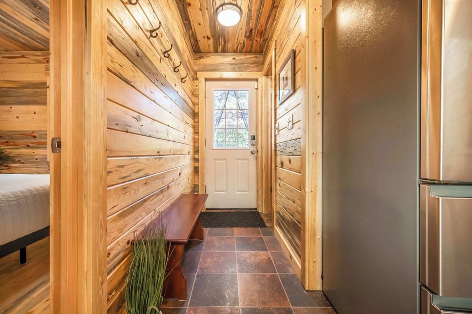 Heading out the back of the cabin towards the large deck with outdoor dining, coffee table & lounge furniture, propane grill & clothes line for drying in the mountain air. To the left is the fire pit, sauna, hammock, frisbee golf & views of the stars
