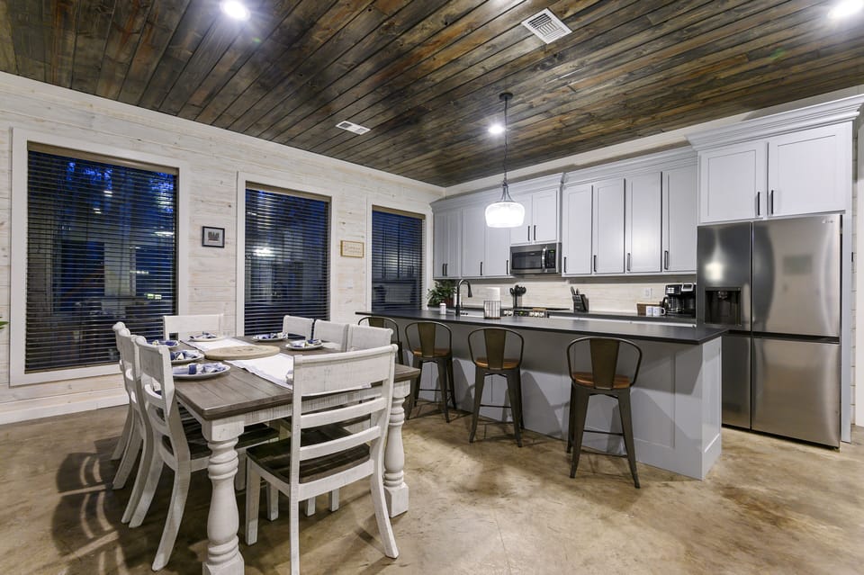 Dining area with a table that seats 8 and additional barstools