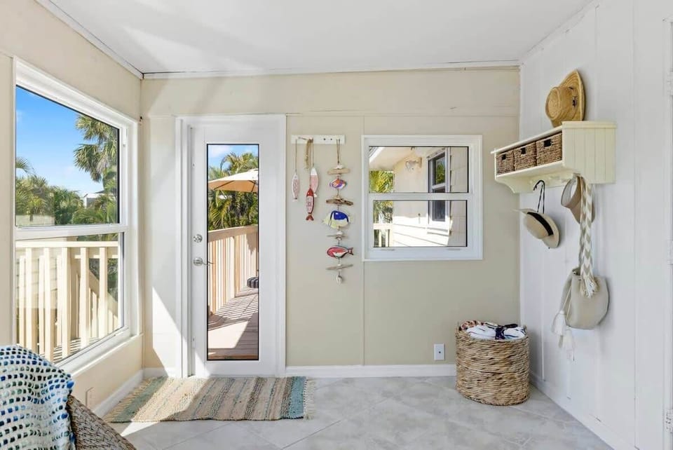 Florida room overlooking pool and lagoon, perfect for reading and relaxing