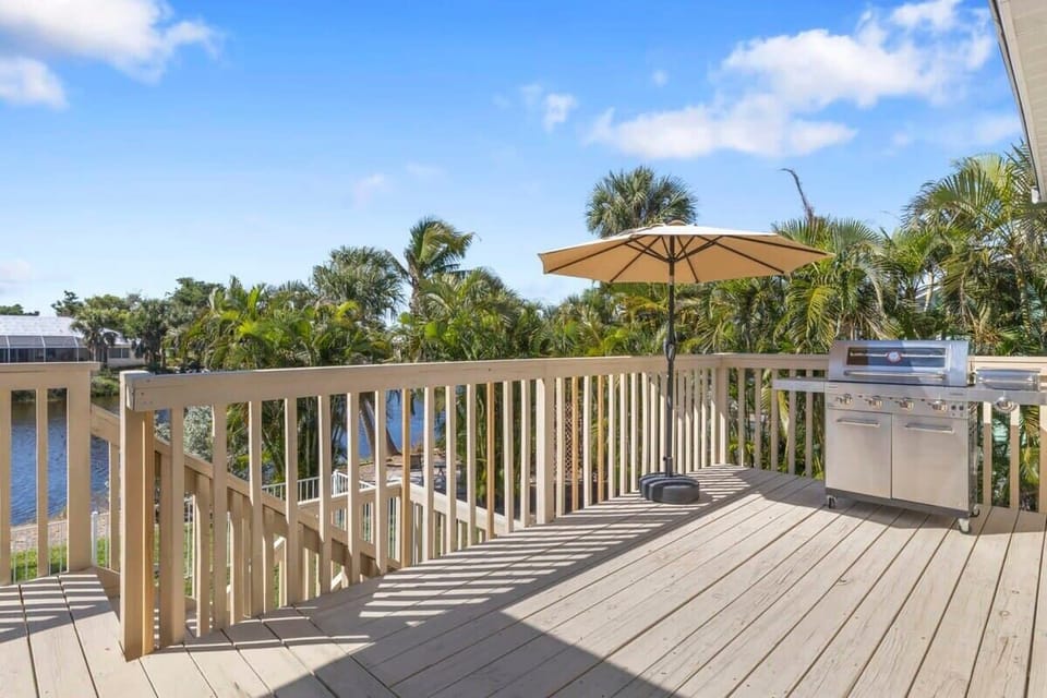 Patio deck with gas grill overlooking pool and lagoon