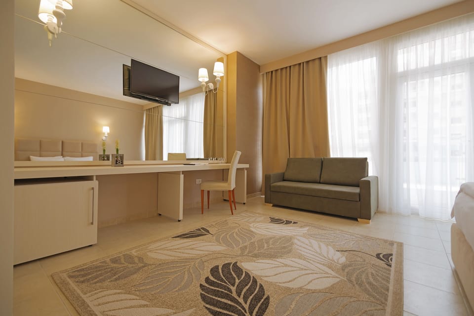 Suite, 1 King Bed, Beach View | Minibar, desk, blackout drapes, iron/ironing board