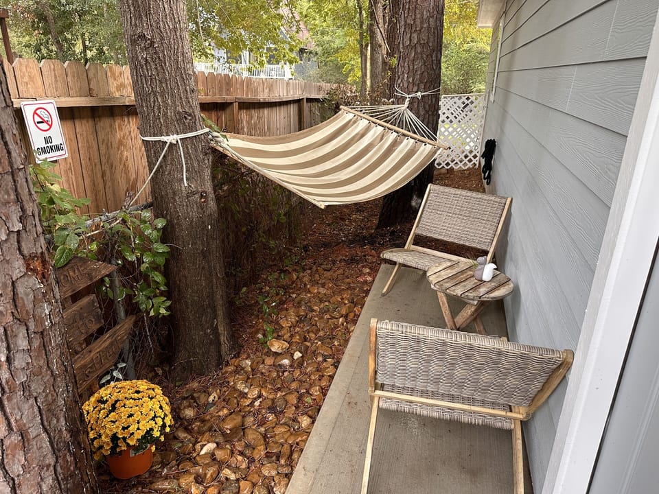 Outdoor sitting area with hammock.