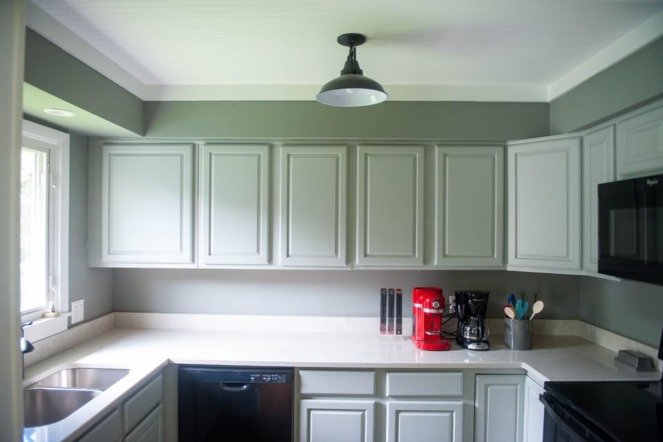 Kitchen features oven, microwave, dishwasher. Espresso & Drip coffee machines. 
