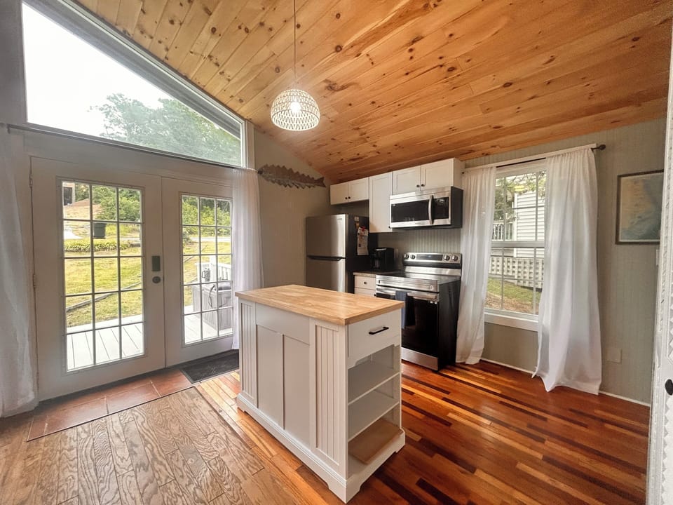 The kitchen features stainless appliances and granite countertops. 