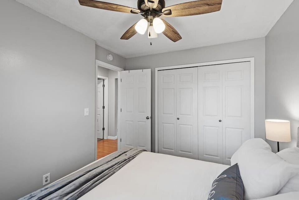 Bedroom 1 View 2 - large closet with hamper and luggage rack. Also featuring dresser and USB/phone charging nightstands