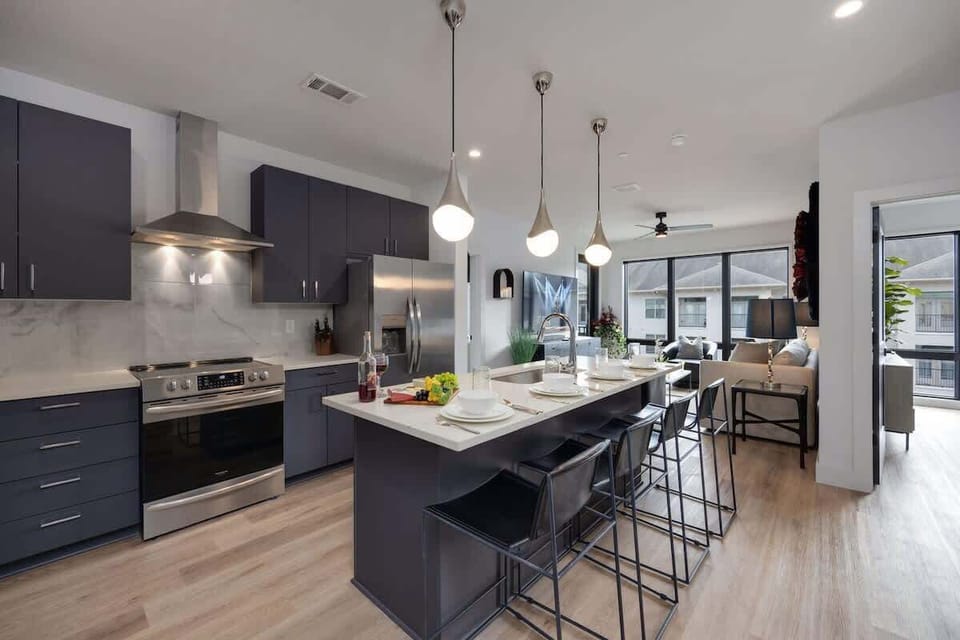 Fully equipped kitchen stocked with your basic cooking essentials. Includes stainless steel appliances, small kitchen island, coffee machine, and toaster.