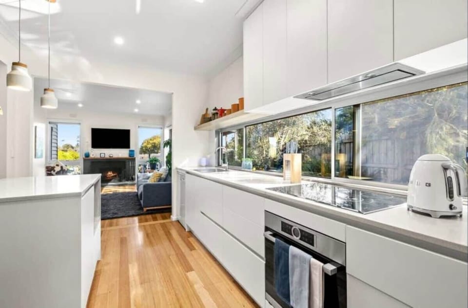 The kitchen features a walk-in pantry, stone countertops, induction cooking - home chefs will adore it!