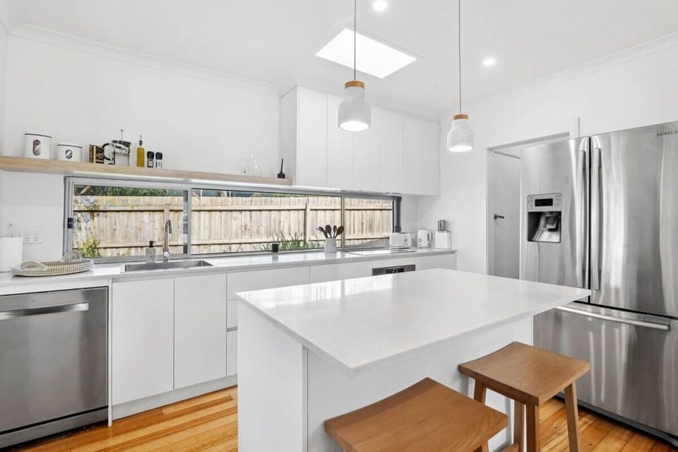 The kitchen is a culinary dream featuring stone countertops, ample storage and electric cooking