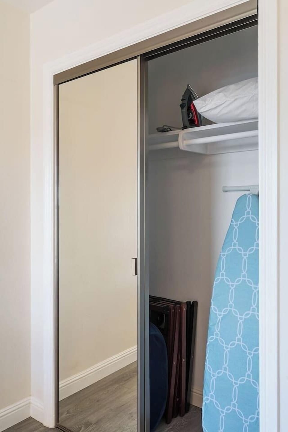 Closet in bedroom (2) with a full body mirror, a space where you'll find the iron and ironing board.