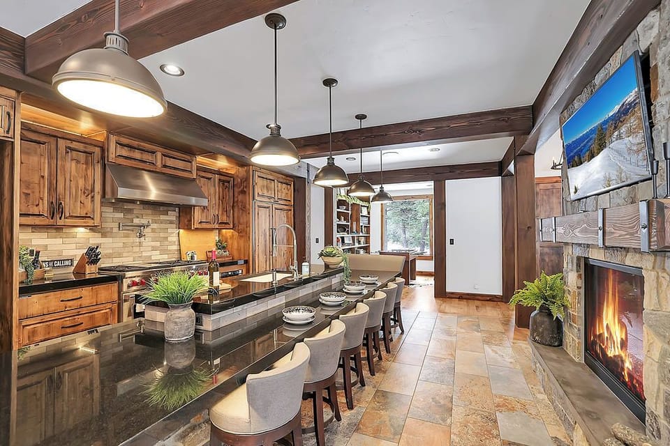 A real cook’s kitchen: Wolf gas range, Sub‑Zero fridge, huge island, and plenty of space for everyone to linger with a glass of wine.