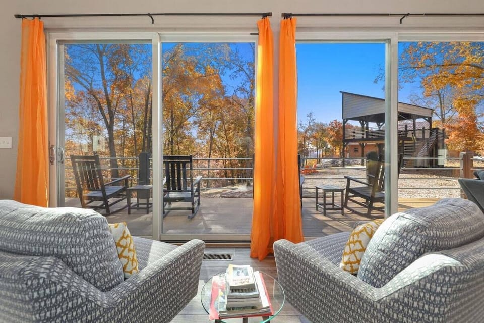 Enjoy the beautiful landscape from the large windows, wrap-around porch, fire pit, or upper deck with cozy outdoor seating!