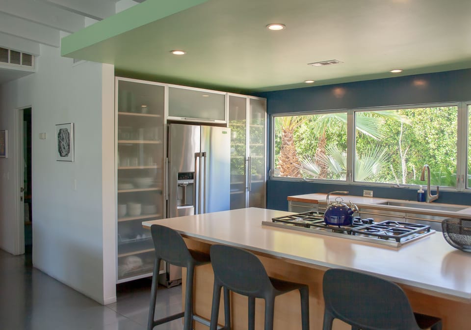 Spacious chef's kitchen with island seating and indoor-outdoor connection