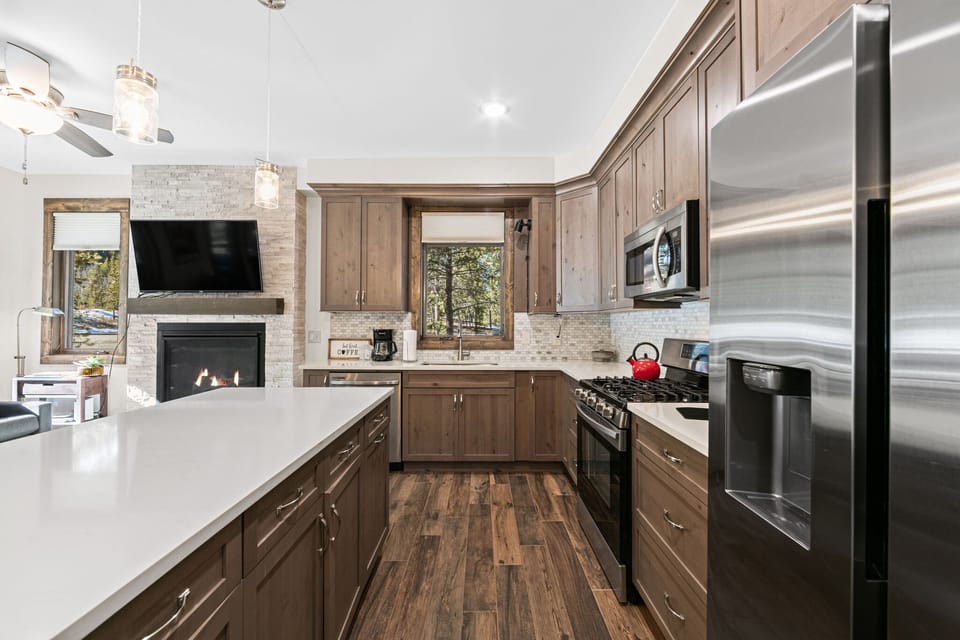 Your gourmet kitchen features granite counters, stainless appliances, and a cozy fireplace for memorable cooking experiences.