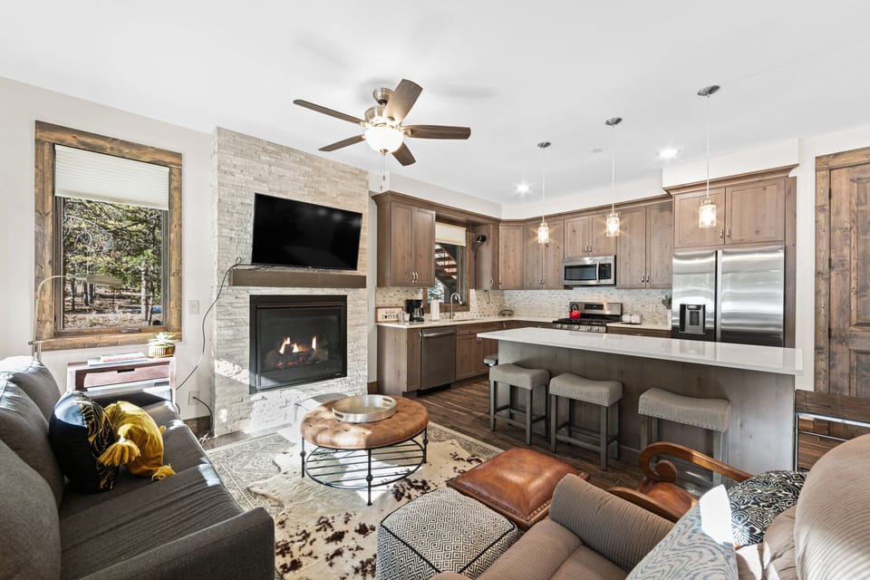 Unwind in your open-concept retreat where a crackling fireplace meets a gourmet kitchen, creating the perfect blend of comfort and culinary adventure.
