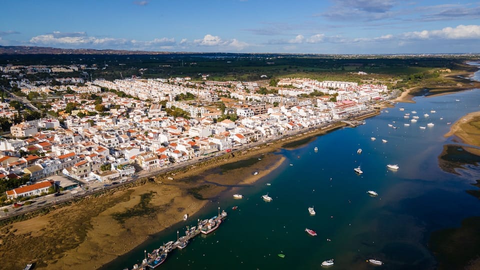 A breathtaking panoramic view of a coastal town nestled by a serene river, dotted with boats under a clear blue sky.
#CoastalView #Riverfront #LovelyStay
