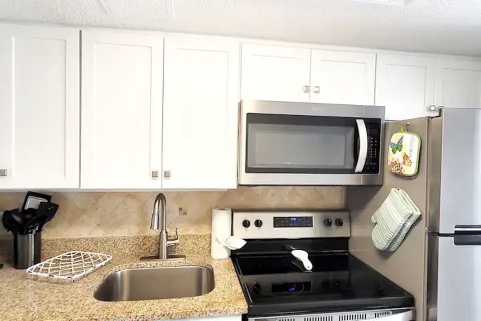 Clean kitchen w/ bright counters ready for simple meals.
