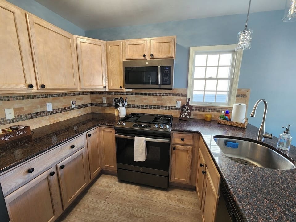 Well appointed kitchen with stainless steel appliances. 