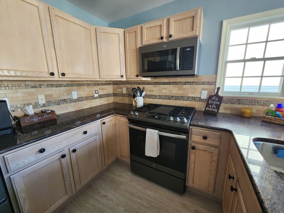 Well appointed kitchen with stainless steel appliances. 