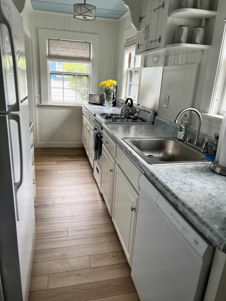 Fully stocked kitchen with dishwasher.