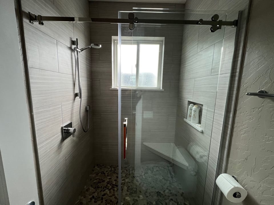 Glass barn door for easy access to shower