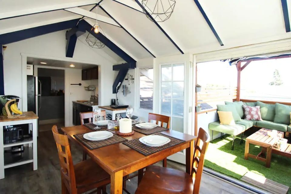 Upstairs sunroom and kitchenette that opens to an outdoor balcony and grill.