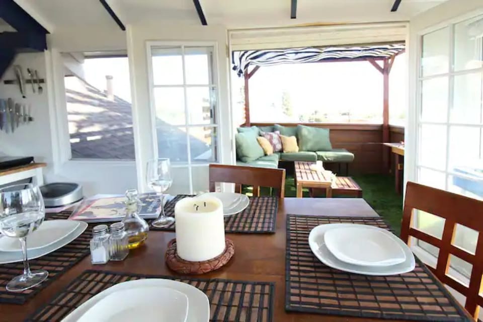 Upstairs sunroom and dining space that opens to the balcony and grill.