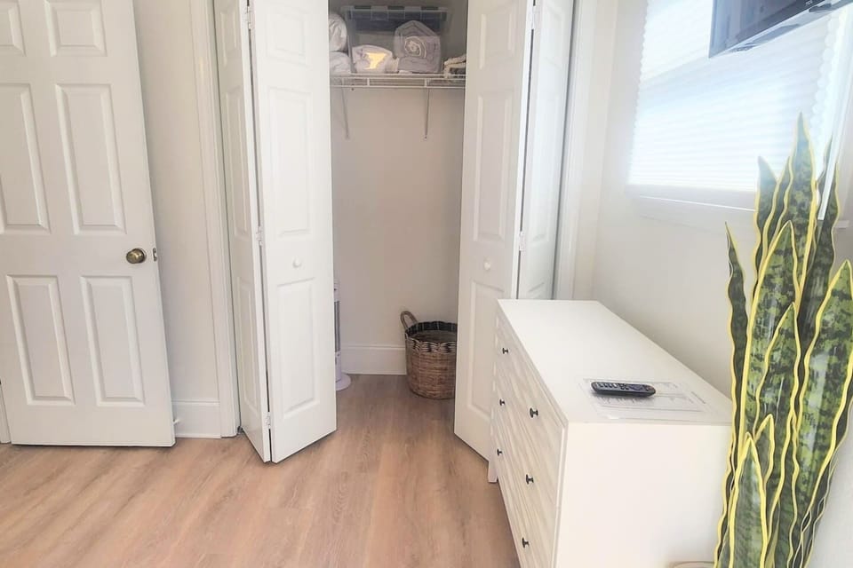 Hang up your clothes and actually unpack — the queen bedroom has enough storage to settle in for the week.