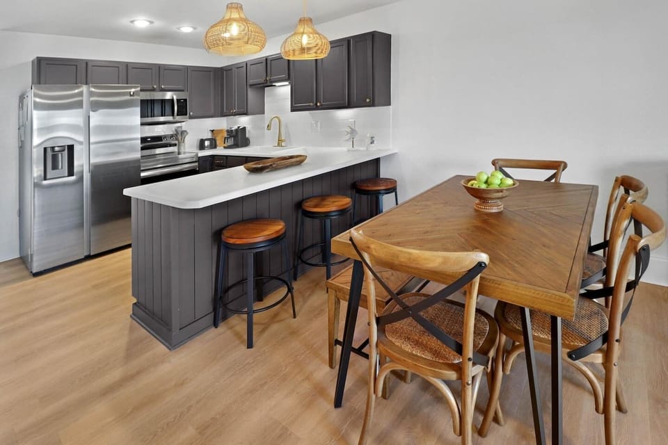 Seat the whole group at the dining table — it comfortably fits nine, so no one gets stuck at the kitchen counter.