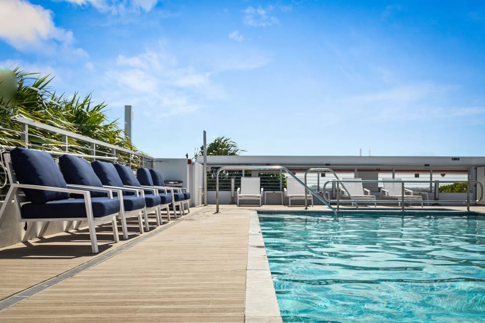 Rooftop pool and jacuzzi with lounge chairs at Bay Harbor Islands vacation rental near Bal Harbor Shops and Surfside Beach, perfect for family-friendly Miami getaways