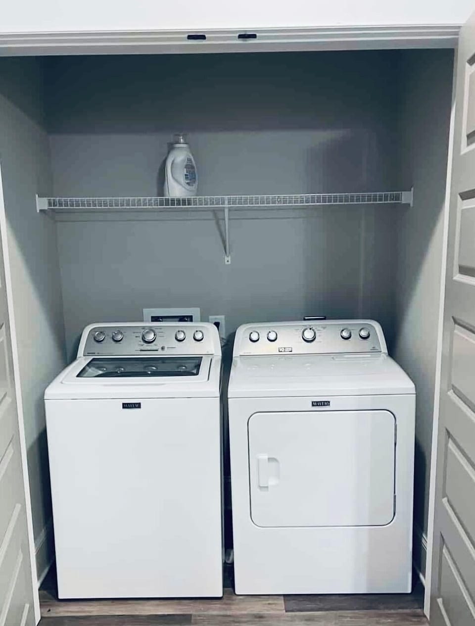 Laundry room with full size washer and dryer, plus iron and ironing board