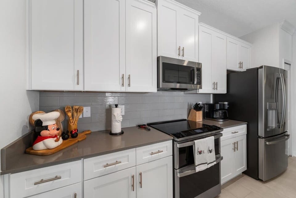 Fully stocked kitchen featuring modern appliances and an oversized island.
