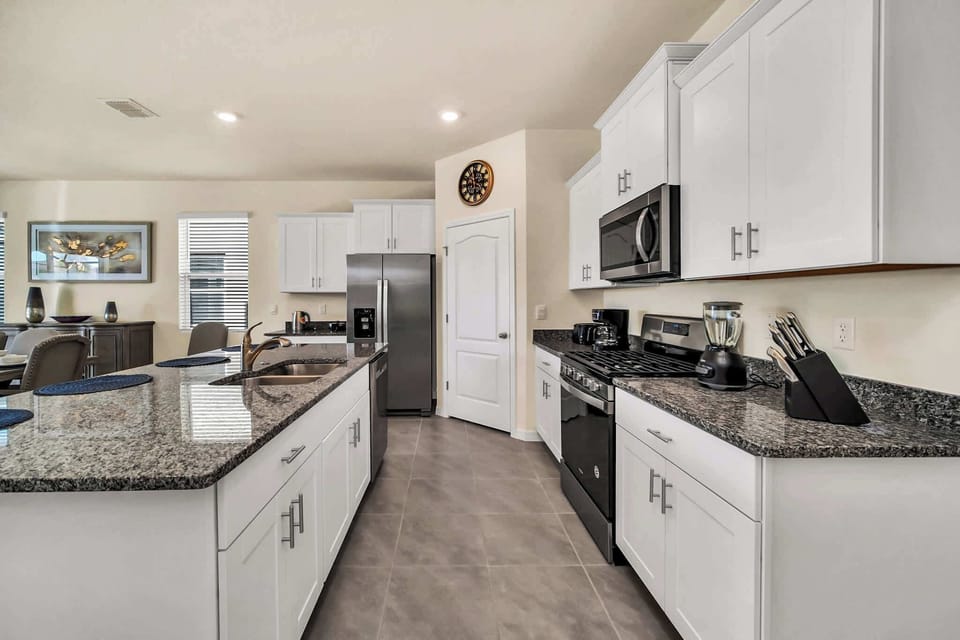 Spacious modern kitchen with sleek granite countertops and stainless steel appliances, perfect for culinary adventures.