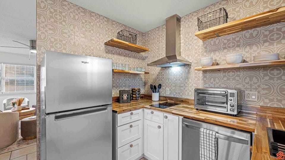 Fully equipped with modern appliances and plenty of counter space.