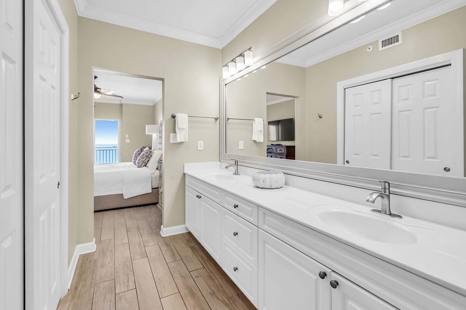 Featuring a stylish countertop with double sinks, this bathroom combines practicality with a touch of elegance.