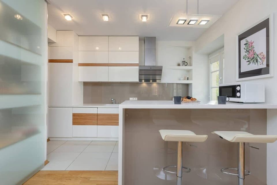 A wider view of the kitchen, revealing extra counter space and a window for natural light.
