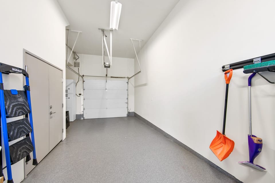 Private garage with convenient storage and cleaning supplies keeps your vehicle secure and gear organized during your stay.