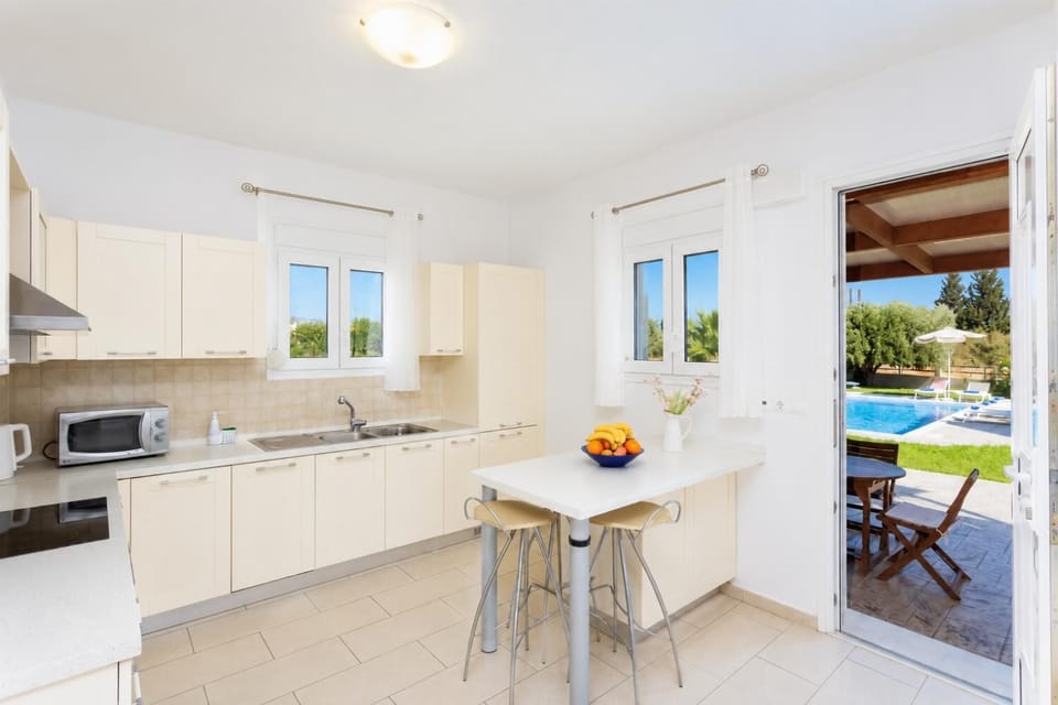 Equipped kitchen with dining area and terrace access